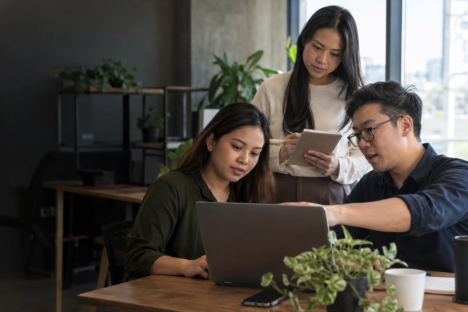 Asian colleagues working together during hands-on software training.